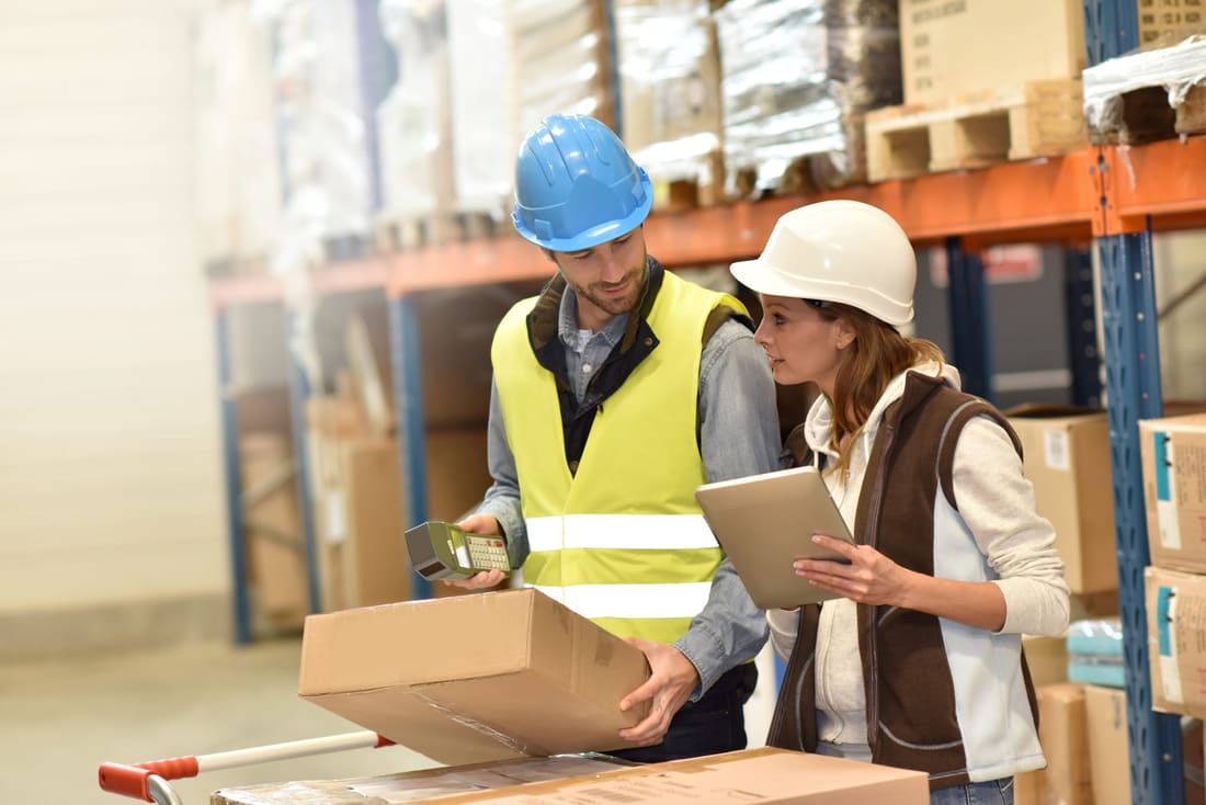 Warehouse staff checking stock levels on a tablet